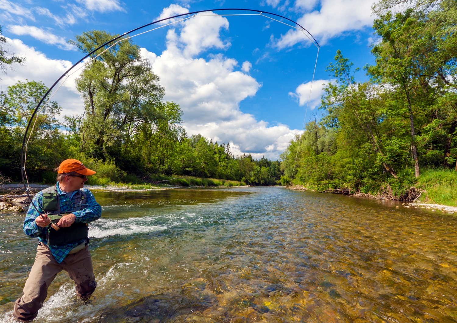 A fisherman fly fishing in a beautiful river